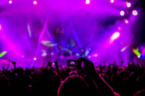 fan taking cell phone photograph of music stage - concert stock pictures, royalty-free photos & images