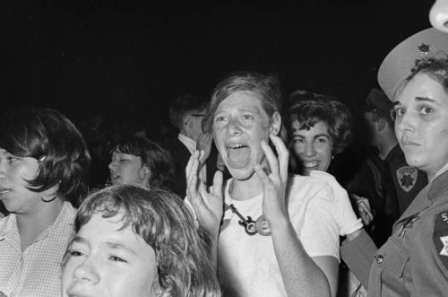 Fans and a police officer at a Beatles concert at the Cow Palace in Daly City, near San Francisco, California, during their Summer 1964 United States...