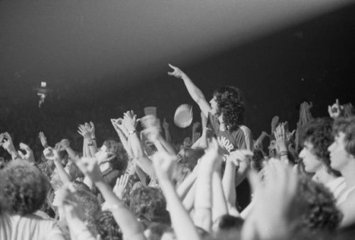 Fans and audience members watch English rock band Led Zeppelin perform live on stage on the third of three nights at Madison Square Garden, New York...