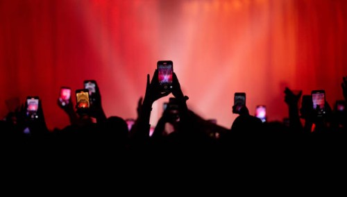 Fans holding their mobile phones high in the air to record gig at O2 Academy Bournemouth on March 09, 2023 in Bournemouth, England.