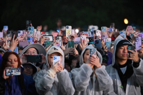 Fans record with their phones as South Korean singer Jungkook performs onstage during the Global Citizen Festival at Central Park in New York City on...