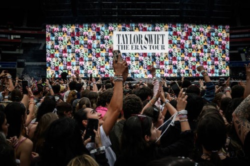 Fans wait for the arrival on stage of US singer and songwriter Taylor Swift at the Groupama Stadium as part of The Eras Tour, in Decines-Charpieu,...