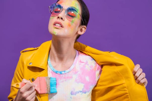 fashion artist painter girl with brush painting herself t-shirt on purple - fashion stock pictures, royalty-free photos & images