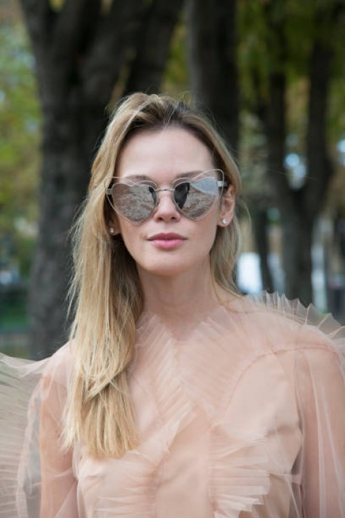 Fashion blogger Anastasiia Masiutkina wears a Nadya Pzyak dress and Saint Laurent sunglasses day 5 of Paris Womens Fashion Week Spring/Summer 2018,...