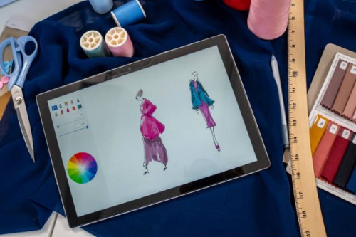 fashion designer draws a sketch of women's clothing. - fashion stock pictures, royalty-free photos & images