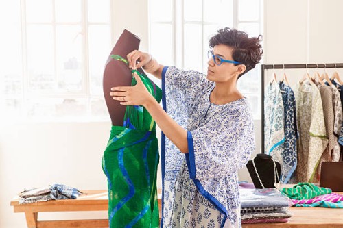 fashion designer working on dress on dummy . - fashion stock pictures, royalty-free photos & images