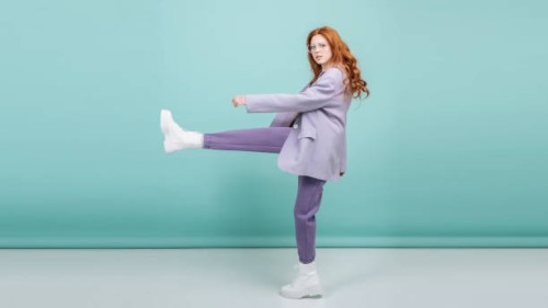 fashion model makes a step posing on a colored background with copy space. fashion and trend concept - fashion stock pictures, royalty-free photos & images