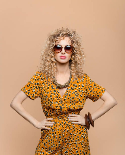 fashion portrait of woman in leopard print dress - fashion stock pictures, royalty-free photos & images