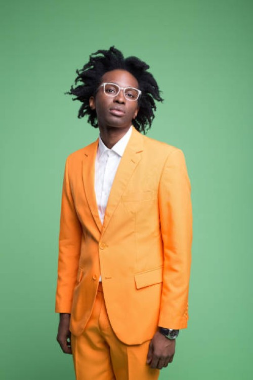 fashion portraot of elegant man in orange suit - fashion stock pictures, royalty-free photos & images