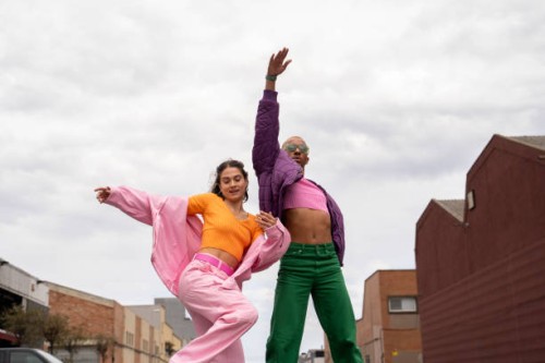 fashionable couple dancing together in front of sky - fashion stock pictures, royalty-free photos & images