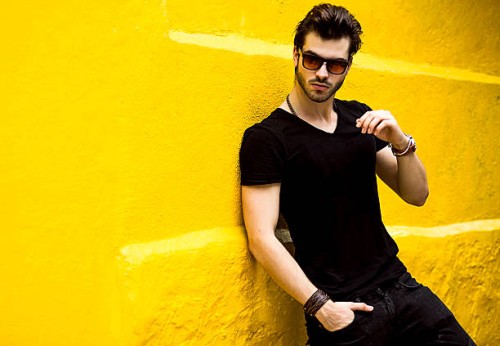 fashionable handsome man isolated on yellow wall - fashion stock pictures, royalty-free photos & images
