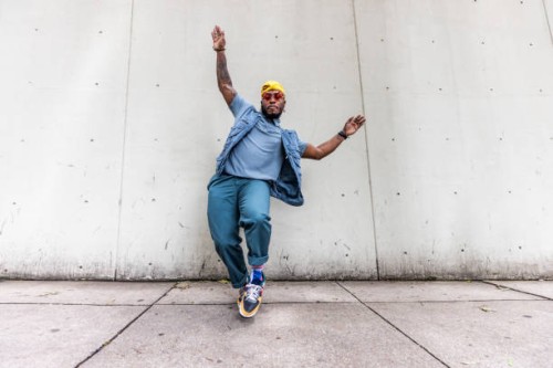 fashionable male professional dancer on urban sidewalk, full length - fashion stock-fotos und bilder