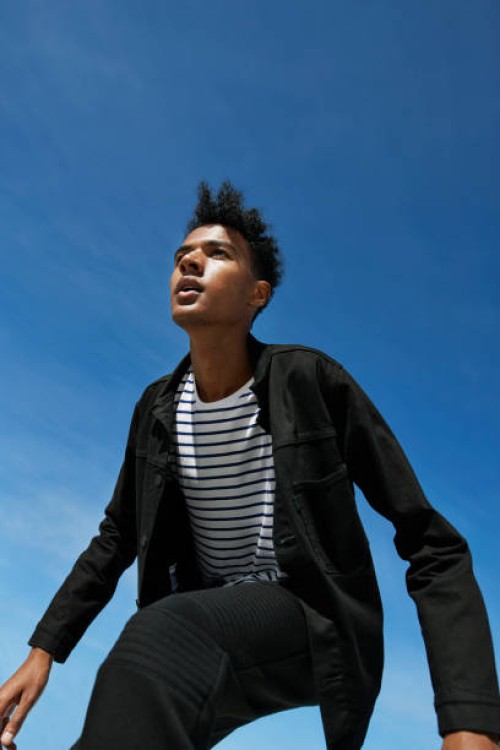 fashionable man looking away against blue sky - fashion stock pictures, royalty-free photos & images