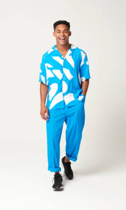 fashionable man walking with hands in pocket - fashion stock pictures, royalty-free photos & images