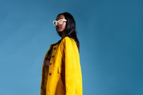 fashionable woman in a yellow coat - fashion stock pictures, royalty-free photos & images