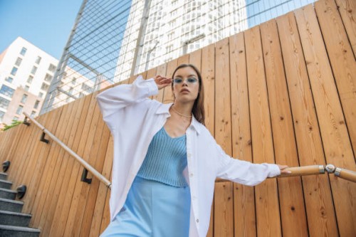 fashionable woman in glasses looking at the camera in trendy fashionable clothes outdoors on a city street. fashion and sale concept - fashion stock pictures, royalty-free photos & images