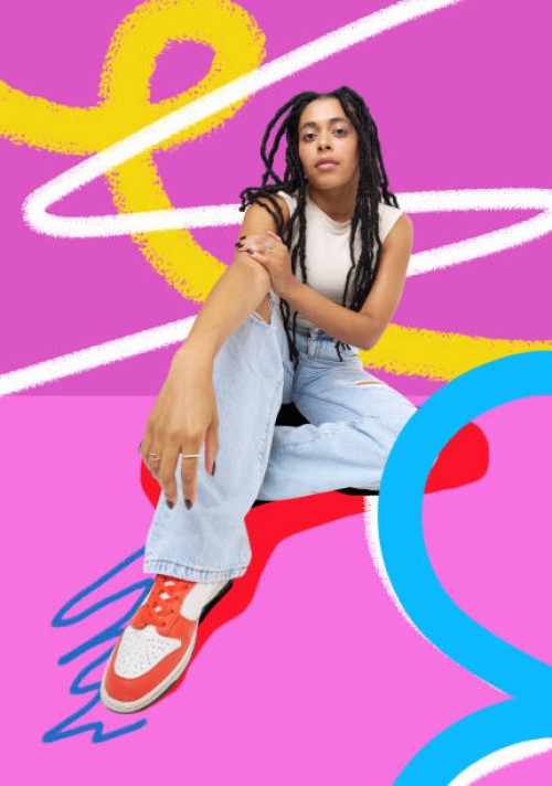 fashionable woman sitting against colourful background - fashion stock pictures, royalty-free photos & images