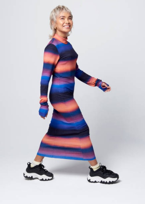 fashionable woman walking in studio - fashion stock pictures, royalty-free photos & images