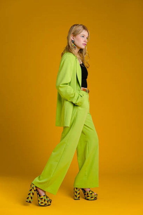 fashionable woman wearing green suit - fashion stock pictures, royalty-free photos & images
