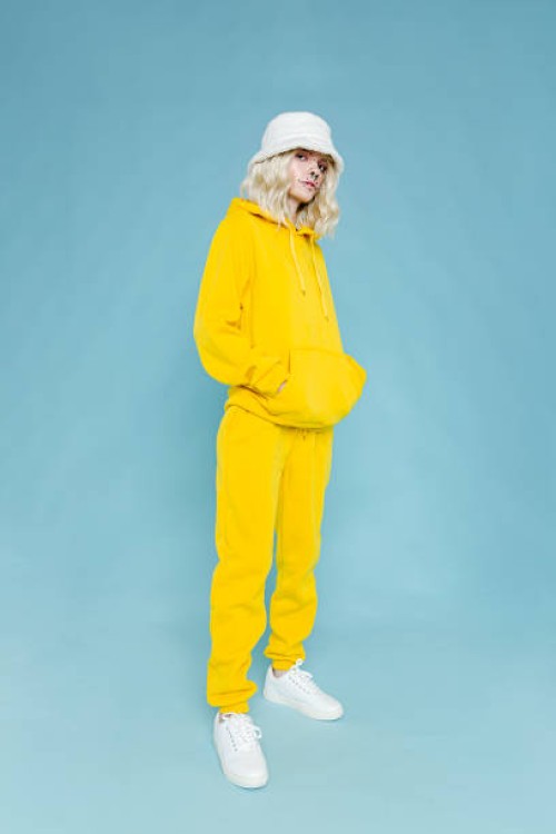 fashionable woman wearing yellow track suit - fashion stock pictures, royalty-free photos & images