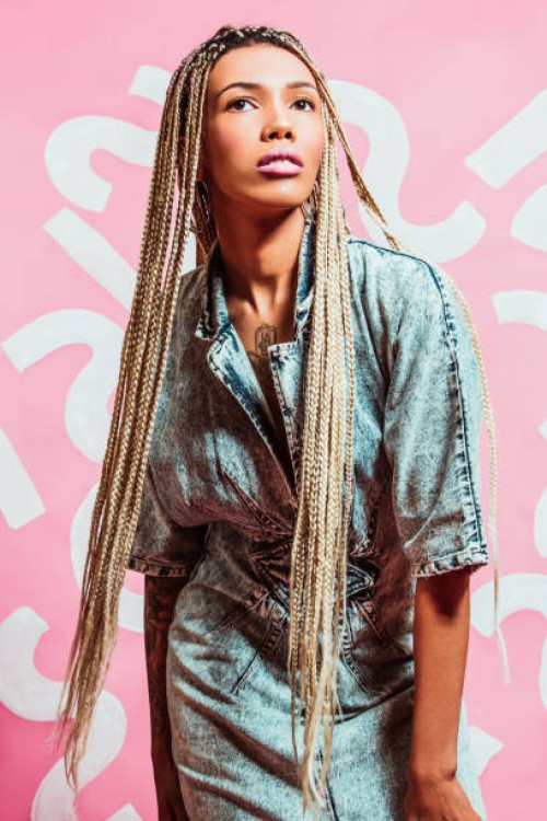 fashionable woman with long braids wearing acid wash denim dress late 1980s style, early 1990s style - fashion stock pictures, royalty-free photos & images