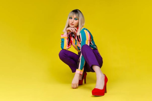 fashionable young woman in colorful outfit - fashion stock pictures, royalty-free photos & images
