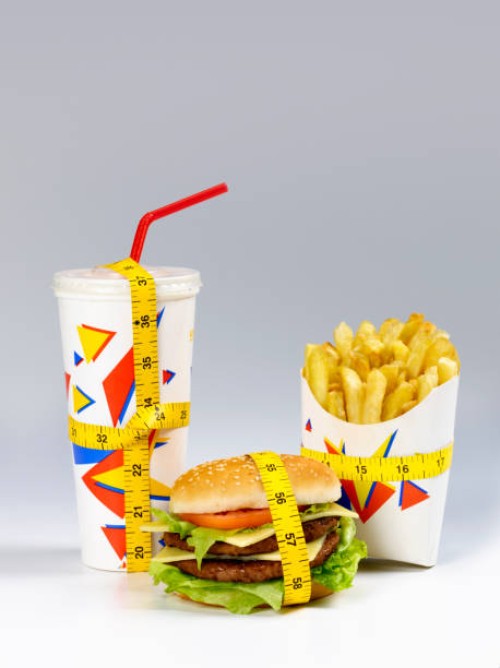 fast food meal with tape measure - junk food stock pictures, royalty-free photos & images