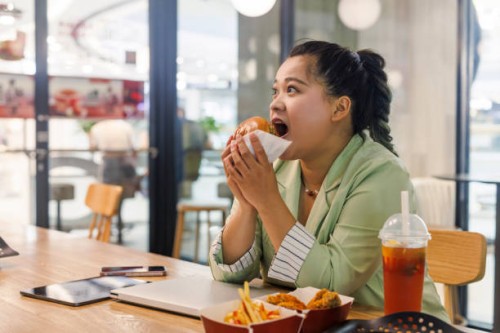 fat asian business women happy hamburgers in fast food restaurants - junk food stock pictures, royalty-free photos & images