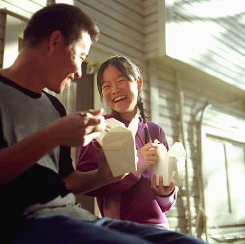 father and daughter (12-14) eating chinese food, laughing - junk food stock pictures, royalty-free photos & images