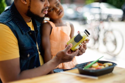 father and daughter eating take out food outdoors. - junk food stock pictures, royalty-free photos & images
