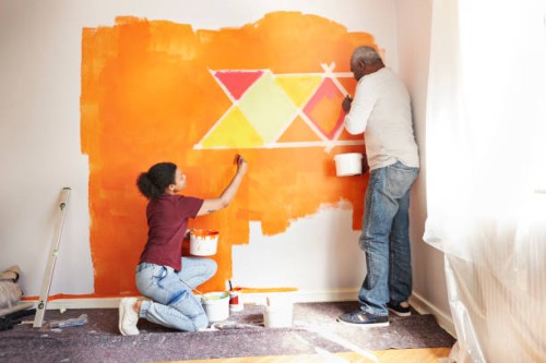 father and daughter painting wall at home - home decoration stock pictures, royalty-free photos & images