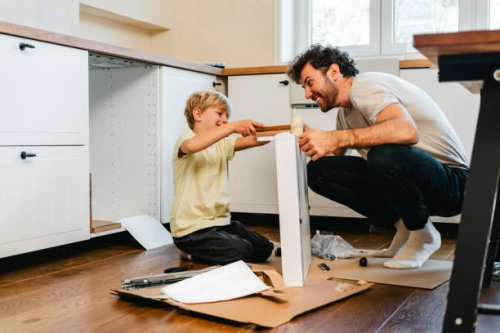 father and son assembling kitchen furniture - home decoration stock pictures, royalty-free photos & images
