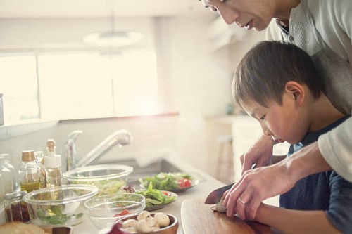 father and son cooking together at home - food stock pictures, royalty-free photos & images