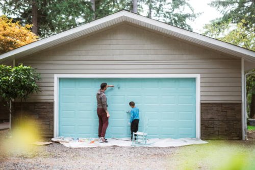 father and son painting garage door together - home decoration stock pictures, royalty-free photos & images