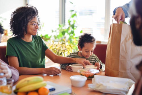 father having take away food with his children at home. - junk food stock pictures, royalty-free photos & images