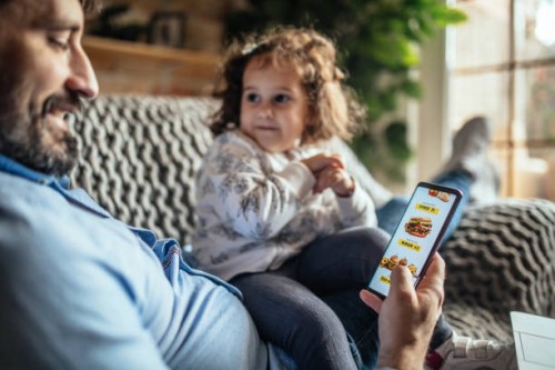 father ordering food online on the phone - junk food stock pictures, royalty-free photos & images