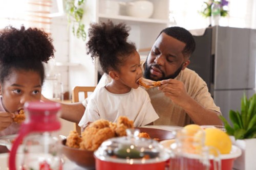father taking care of their kids eating - junk food stock pictures, royalty-free photos & images