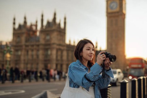 female asian tourist taking photos with camera while exploring the city of london - travel stock pictures, royalty-free photos & images