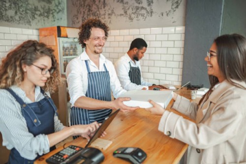 female customer buying pizza for takeout at the bar - junk food stock pictures, royalty-free photos & images