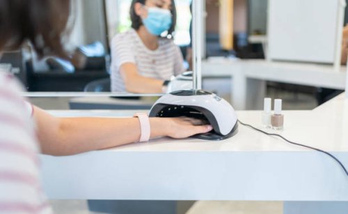 female customer putting hand i̇nto uv lamp dryer i̇n beauty salon - nails art stock pictures, royalty-free photos & images