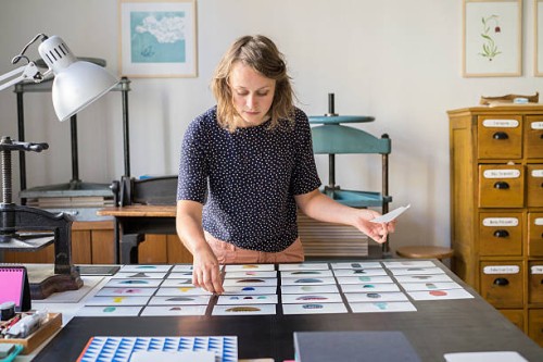 female designer checking photos of ceramics - home decoration stock pictures, royalty-free photos & images