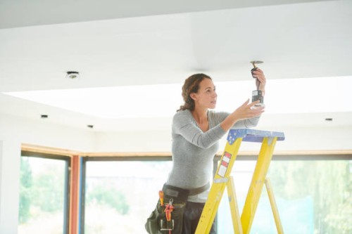 female electrician installing downlights - home decoration stock pictures, royalty-free photos & images