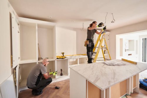 female electrician working in a kitchen remodelling - home decoration stock pictures, royalty-free photos & images