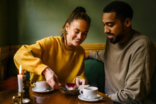 female enjoying raspberry dessert while boyfriend watches - food fotografías e imágenes de stock
