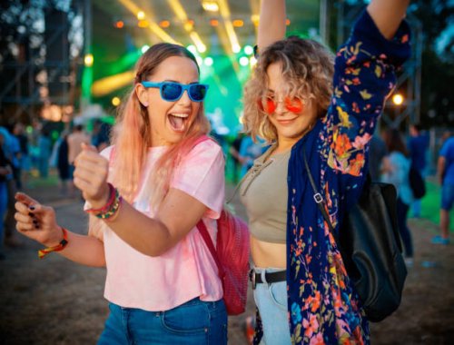 female friends dancing and raising arms to good music on festival - concert stock pictures, royalty-free photos & images