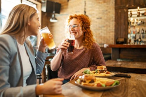 female friends having a beer - junk food stock pictures, royalty-free photos & images