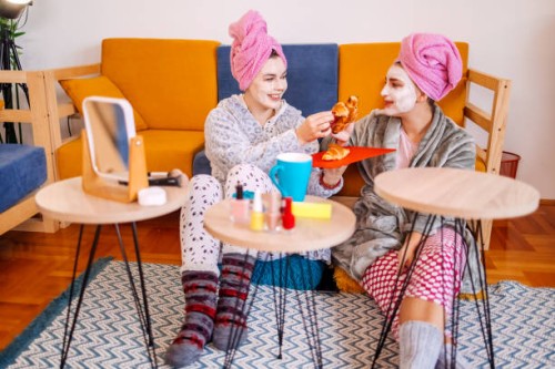 female friends having face cosmetic treatment at home - home decoration stock pictures, royalty-free photos & images