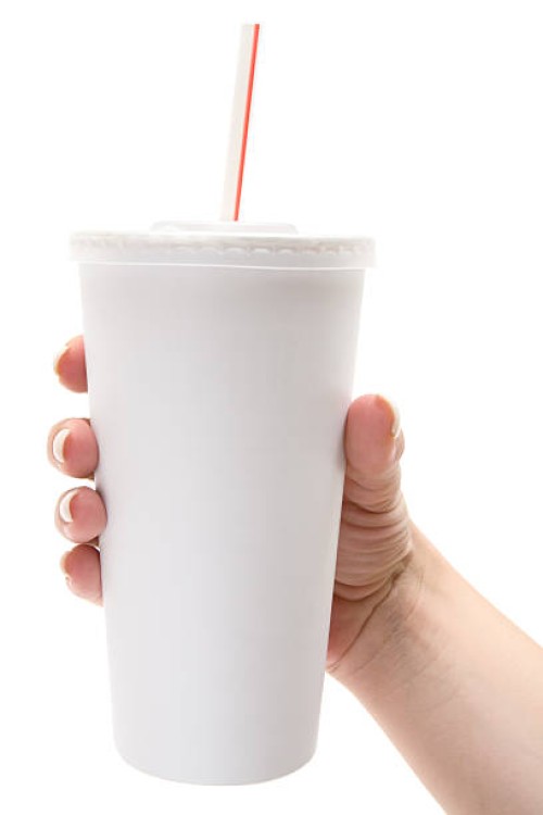 female hand holds white disposable cup - junk food stock pictures, royalty-free photos & images