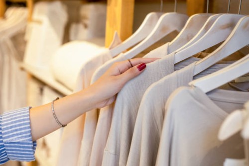 female hand taking a clothes out at clothing store - fashion stock pictures, royalty-free photos & images