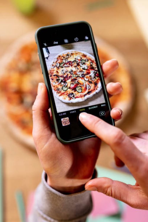 female hand with cell phone taking pictures of pizza - junk food stock pictures, royalty-free photos & images